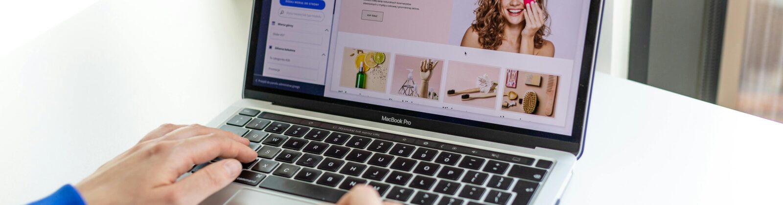 Hands typing on a laptop with an e-commerce website open, showcasing online shopping.